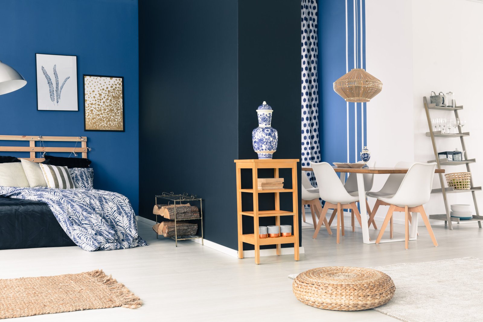 Stylish white and blue studio with wooden furniture